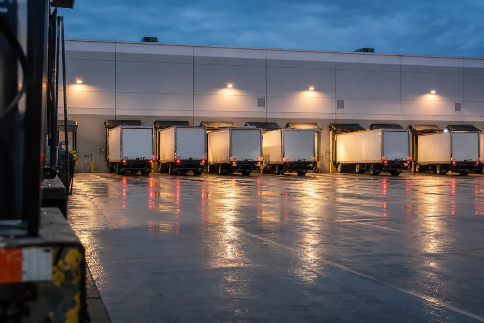 Box trucks backed into warehouse loading docks, a commercial auto and cargo account